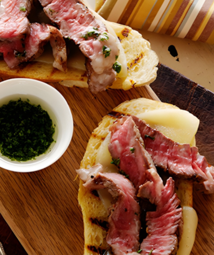 Mini Open Faced Steak Sandwiches on Garlic Bread with Aged Provolone and Parsley Oil